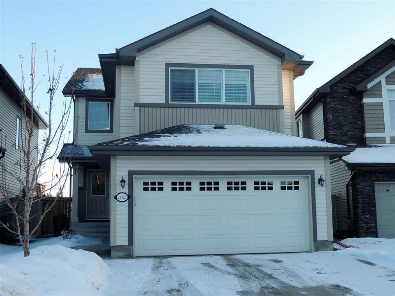 A white and snowy exterior of a house